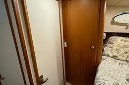 Slide: The Image of Interior of 1998 Silverton 372 Motor Yacht cabin with bed and wooden door. - 39