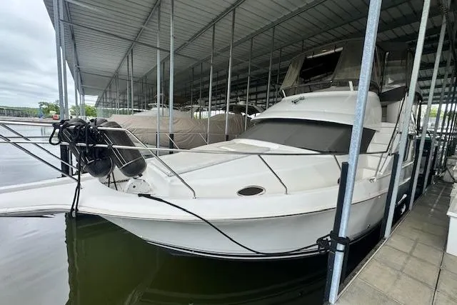 Slide: The Image of 1998 Silverton 372 Motor Yacht docked in covered marina. - 4