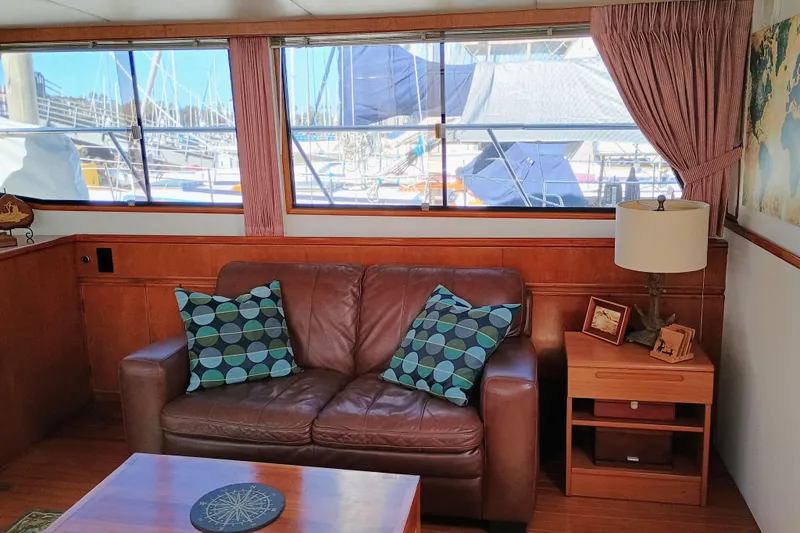 Slide: The Image of Interior of 1988 Vantare 46' Aft Cabin yacht with leather sofa and nautical decor. - 13