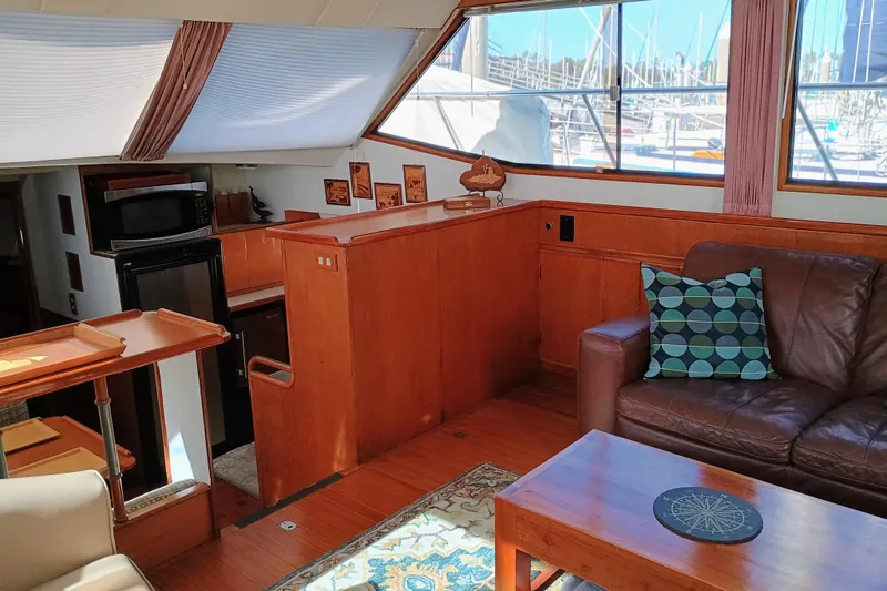 Slide: The Image of Interior of 1988 Vantare 46' Aft Cabin Wide Body MY with cozy seating and nautical decor. - 14