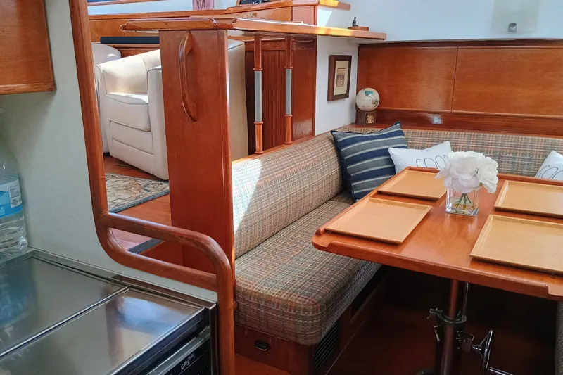 Slide: The Image of 1988 Vantare 46' Aft Cabin yacht interior with cozy dining area and elegant wood finishes. - 17