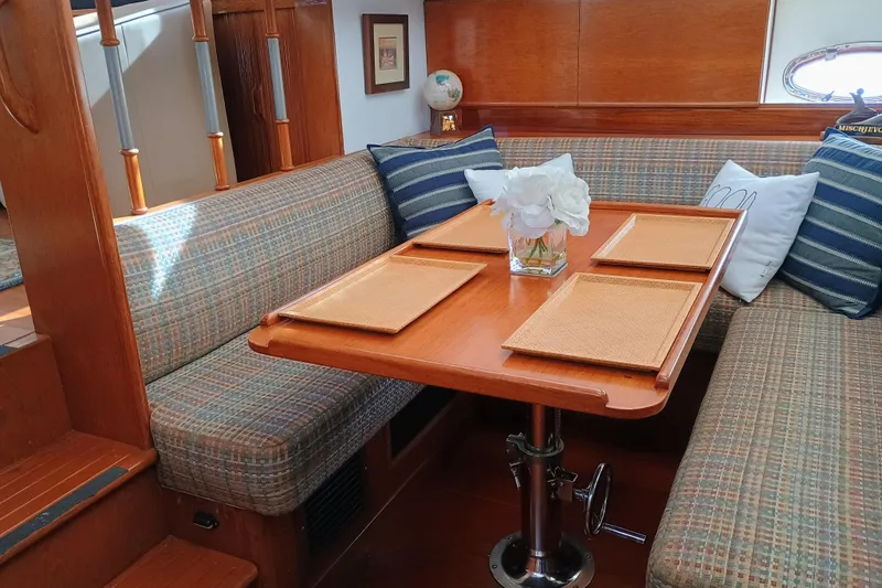 Slide: The Image of Interior of 1988 Vantare 46' Aft Cabin Wide Body MY with cozy dining area. - 18