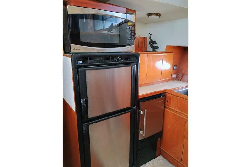 Slide: The Image of Kitchen area of 1988 Vantare 46' Aft Cabin Wide Body MY with appliances. - 19