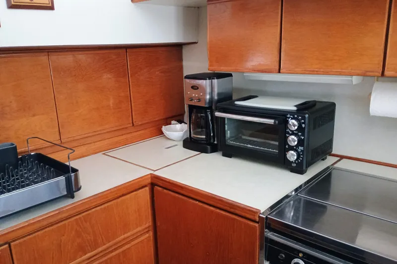 Slide: The Image of 1988 Vantare 46' yacht kitchen with toaster oven and coffee maker on wooden cabinets. - 20