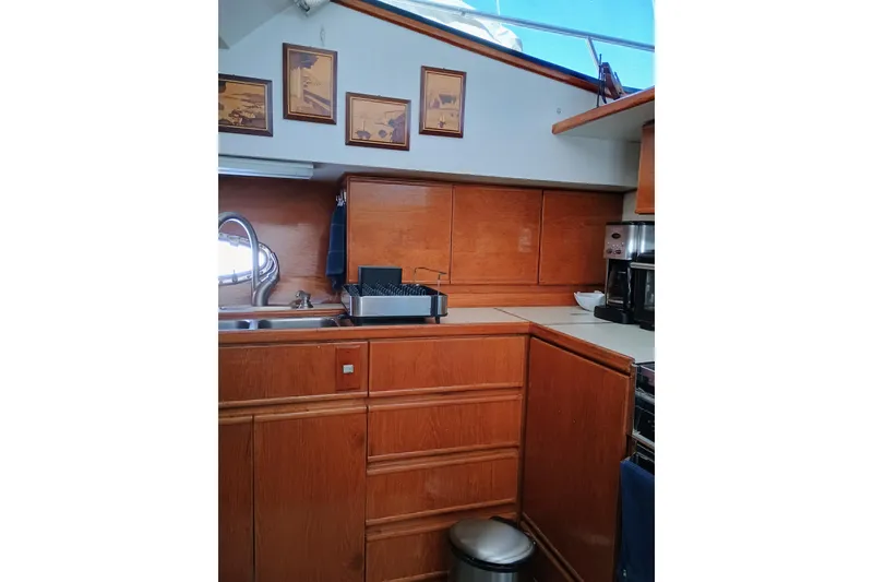 Slide: The Image of 1988 Vantare 46' Aft Cabin yacht kitchen with wood cabinetry and modern appliances. - 21