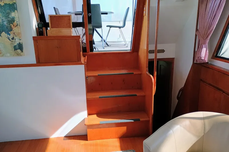 Slide: The Image of Interior of 1988 Vantare 46' Aft Cabin Wide Body MY with wooden stairs and seating area. - 40