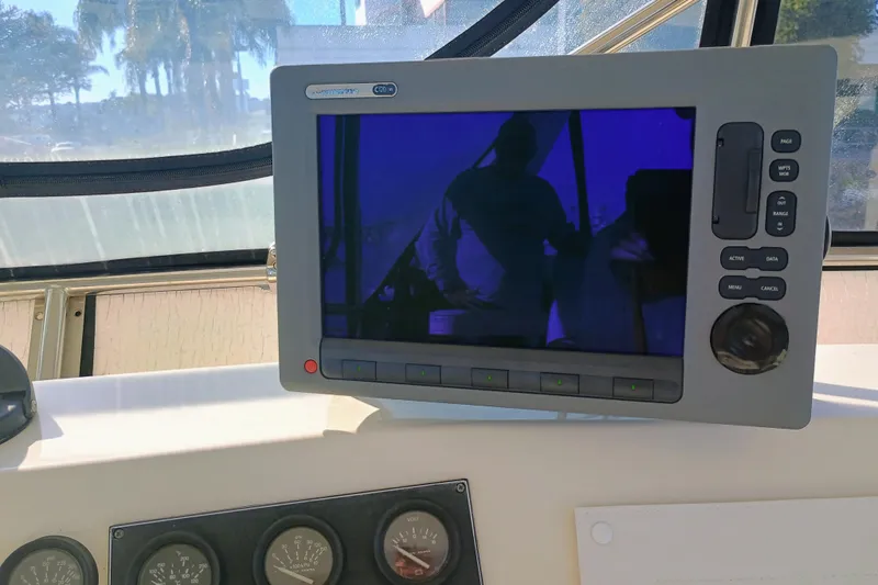 Slide: The Image of 1988 Vantare 46' Aft Cabin yacht dashboard with navigation display and gauges. - 52
