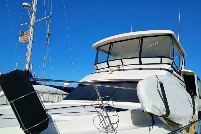 Slide: The Image of 1988 Vantare 46' Aft Cabin Wide Body MY yacht docked under clear blue sky. - 63