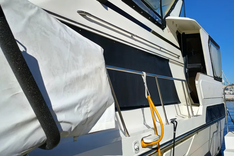 Slide: The Image of 1988 Vantare 46' Aft Cabin Wide Body MY yacht docked, side view. - 64