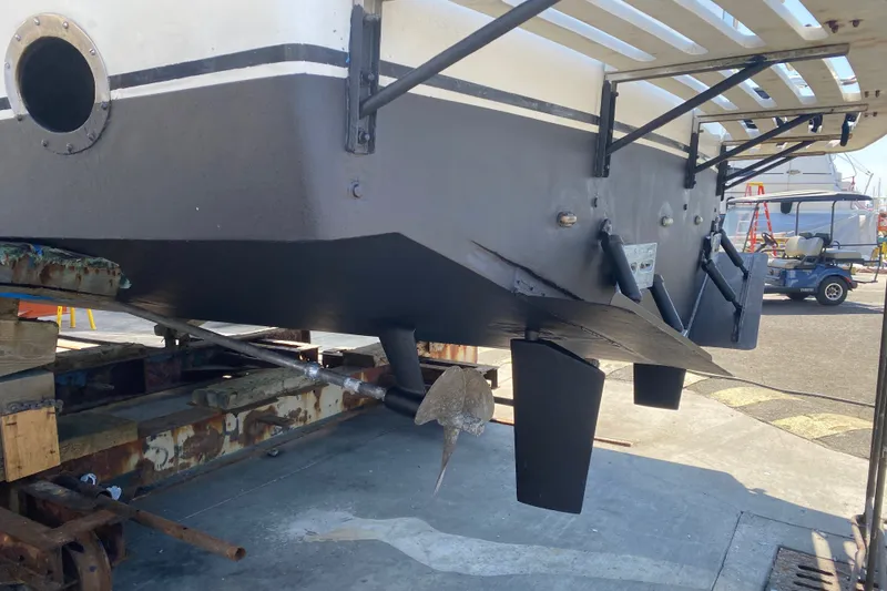 Slide: The Image of 1988 Vantare 46' Aft Cabin Wide Body MY on dry dock, showcasing hull and propeller. - 73
