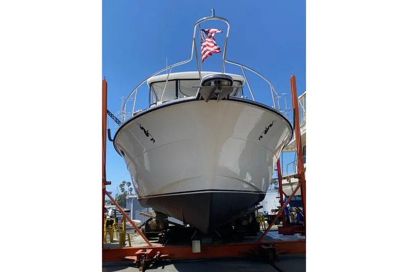 Slide: The Image of 1988 Vantare 46' Aft Cabin Wide Body MY yacht on dry dock with American flag. - 69