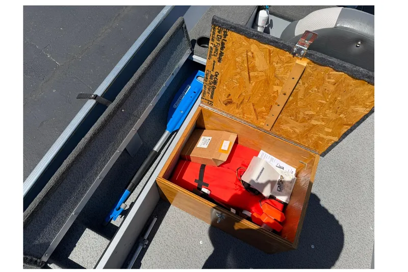 Slide: The Image of Storage compartment in a 2013 Lund 1600 Fury Tiller boat with safety gear and equipment. - 17