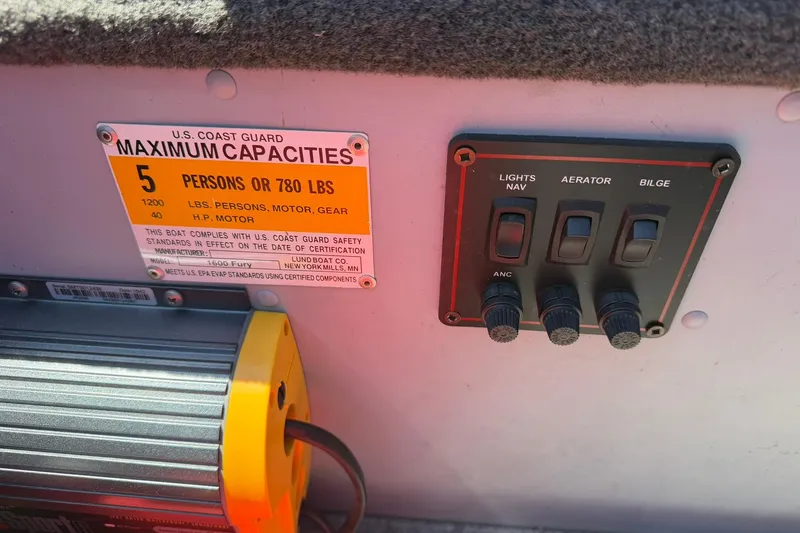 Slide: The Image of Control panel and capacity label on 2013 Lund 1600 Fury Tiller boat. - 18