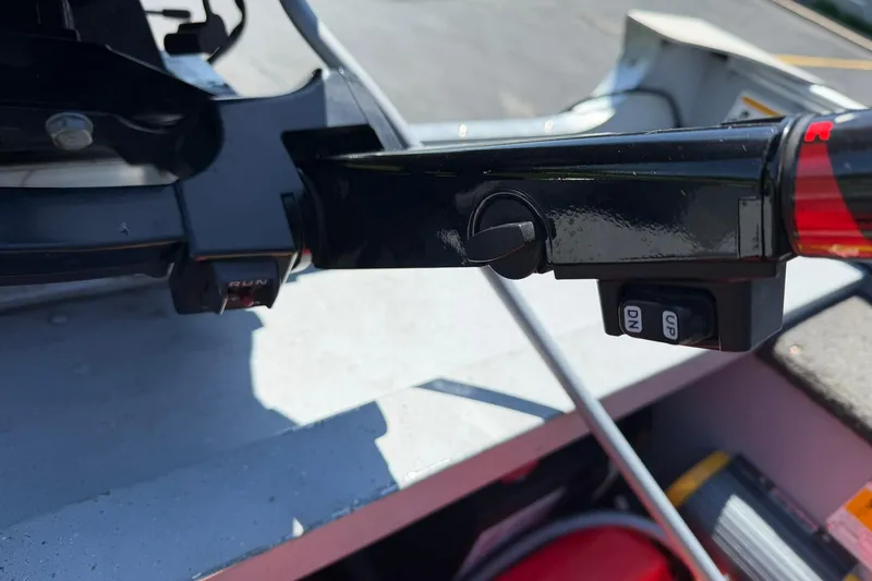 Slide: The Image of Close-up of 2013 Lund 1600 Fury Tiller controls, featuring run and tilt buttons. - 20