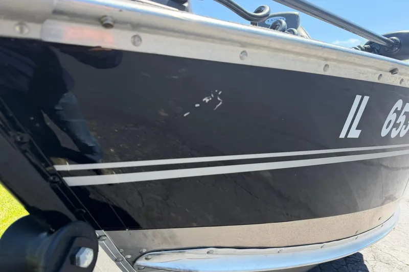 Slide: The Image of 2013 Lund 1600 Fury Tiller boat with visible registration number and minor scratches. - 23