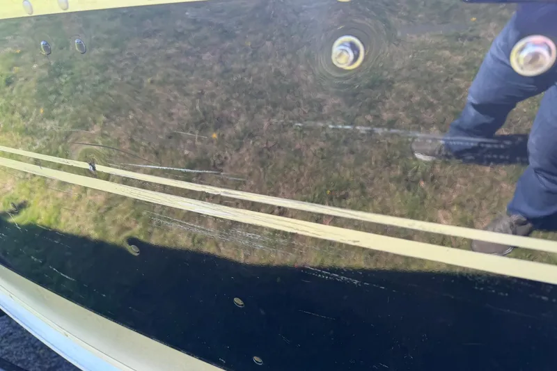 Slide: The Image of Reflection on 2013 Lund 1600 Fury Tiller boat hull with visible rivets. - 24