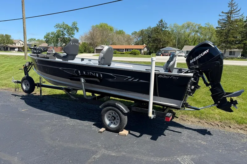Slide: The Image of 2013 Lund 1600 Fury Tiller boat on trailer with Mercury outboard motor. - 4