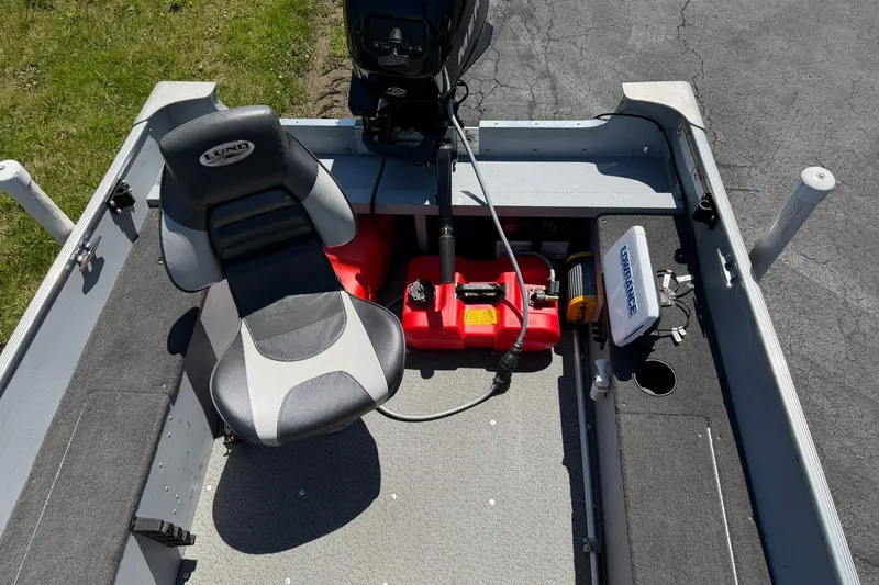 Slide: The Image of 2013 Lund 1600 Fury Tiller boat interior with seat, motor, and equipment. - 5