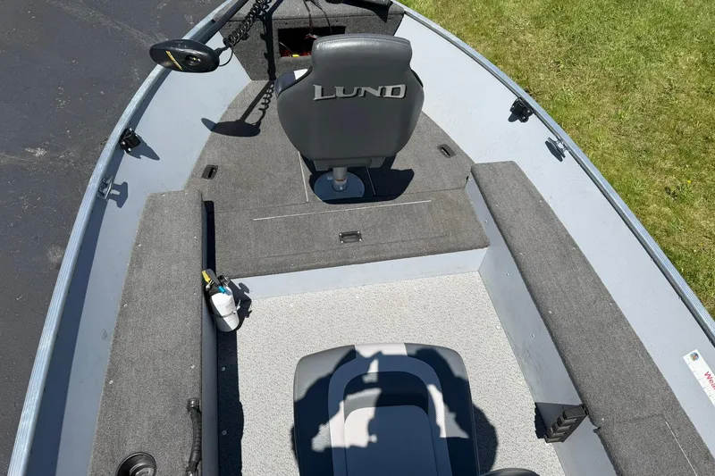 Slide: The Image of 2013 Lund 1600 Fury Tiller boat interior with seating and storage compartments. - 8
