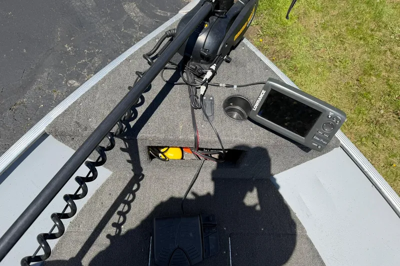 Slide: The Image of 2013 Lund 1600 Fury Tiller boat deck with fish finder and trolling motor. - 9