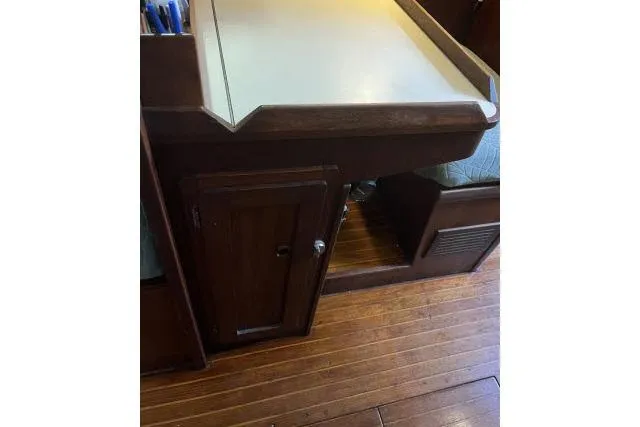 Slide: The Image of 1977 Uniflite Valiant 40 interior with wooden cabinetry and desk area. - 10