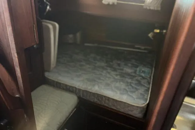 Slide: The Image of Cabin interior of 1977 Uniflite Valiant 40 sailboat with mattress and wooden furnishings. - 15