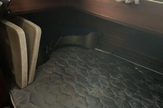 Slide: The Image of 1977 Uniflite Valiant 40 cabin interior with mattress and wooden paneling. - 16