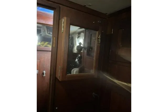 Slide: The Image of 1977 Uniflite Valiant 40 interior with wooden cabinetry and mirrored door. - 18