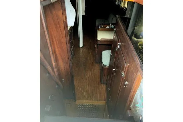 Slide: The Image of 1977 Uniflite Valiant 40 interior with wooden cabinetry and flooring. - 23