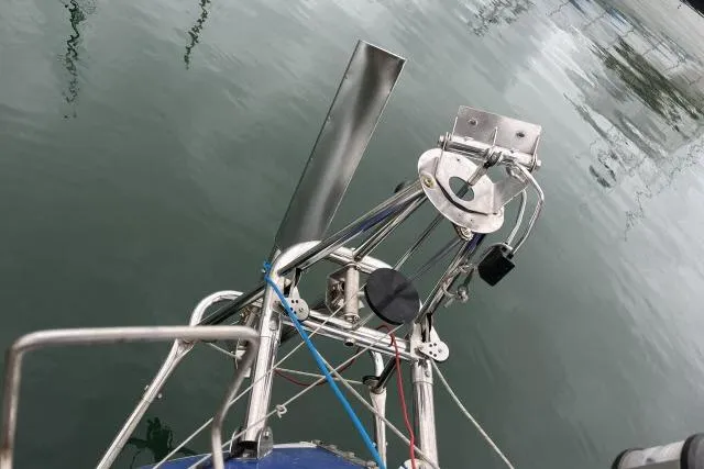 Slide: The Image of Bow of 1977 Uniflite Valiant 40 sailboat with stainless steel fittings and calm water reflection. - 27