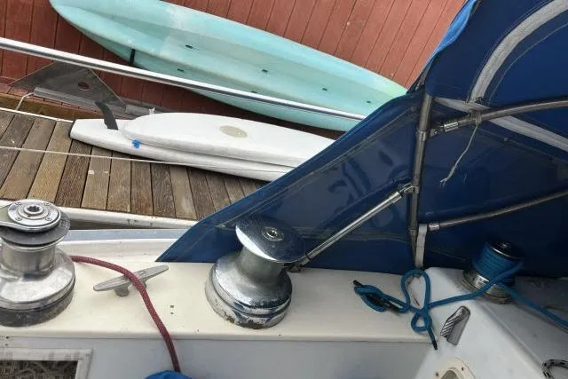 Slide: The Image of 1977 Uniflite Valiant 40 sailboat deck with winches and blue canopy. - 29