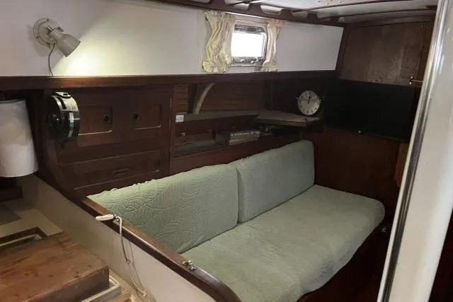Slide: The Image of 1977 Uniflite Valiant 40 interior with wooden cabinetry and cushioned seating. - 3