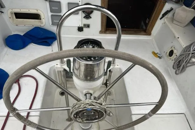 Slide: The Image of Steering wheel and compass on a 1977 Uniflite Valiant 40 sailboat. - 32