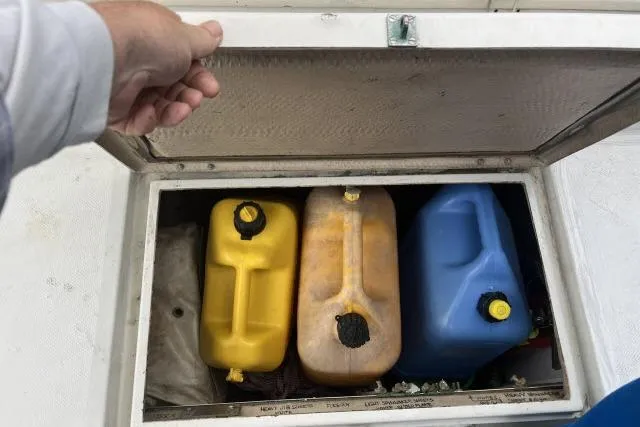 Slide: The Image of Storage compartment on a 1977 Uniflite Valiant 40 with yellow and blue fuel containers. - 34