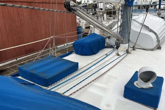 Slide: The Image of 1977 Uniflite Valiant 40 sailboat deck with blue covers and rigging. - 35