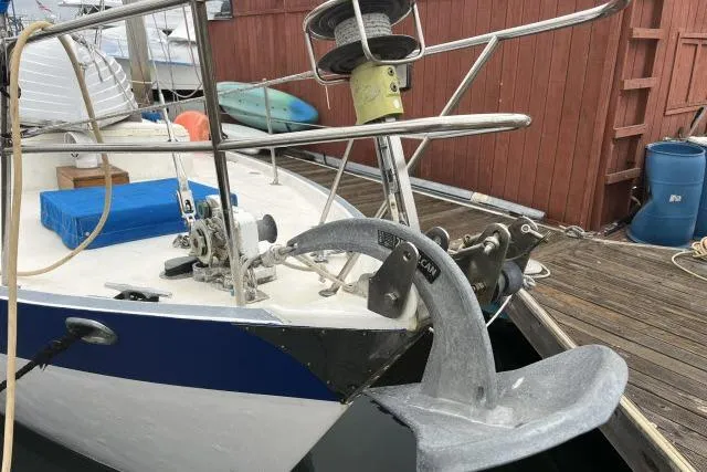 Slide: The Image of 1977 Uniflite Valiant 40 sailboat bow with anchor and winch at dock. - 37