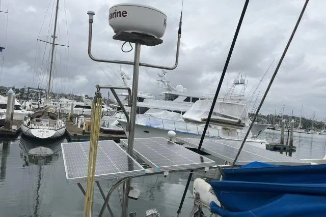 Slide: The Image of 1977 Uniflite Valiant 40 sailboat with solar panels docked at marina. - 38