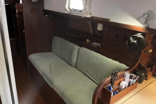 Slide: The Image of 1977 Uniflite Valiant 40 yacht interior with wooden finish and cushioned seating. - 4