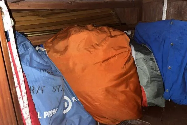 Slide: The Image of Stored sails and equipment inside a 1977 Uniflite Valiant 40 sailboat cabin. - 41