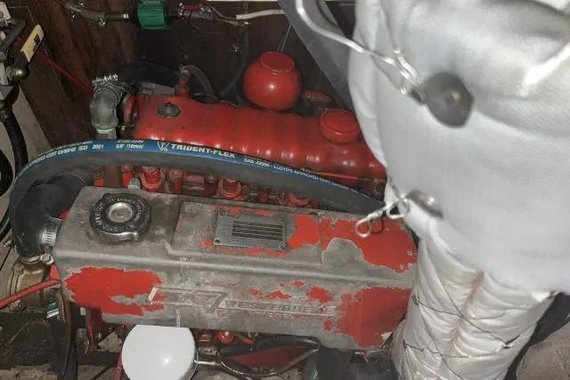 Slide: The Image of Engine compartment of a 1977 Uniflite Valiant 40 sailboat, featuring a red diesel engine. - 42