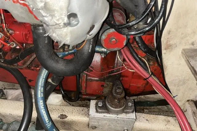 Slide: The Image of Engine compartment of a 1977 Uniflite Valiant 40, showcasing hoses and mechanical components. - 43