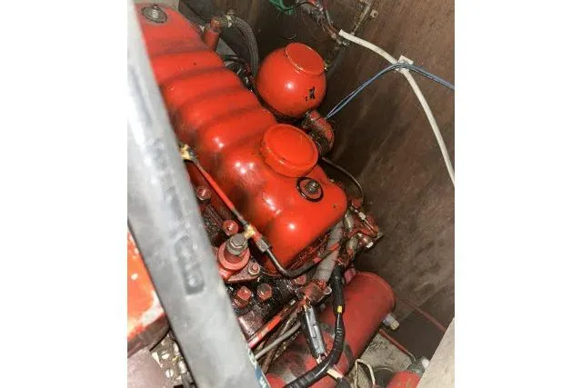 Slide: The Image of Engine compartment of a 1977 Uniflite Valiant 40, featuring a red-painted engine. - 44
