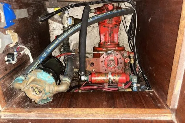 Slide: The Image of Engine compartment of a 1977 Uniflite Valiant 40 sailboat, featuring mechanical components and hoses. - 45