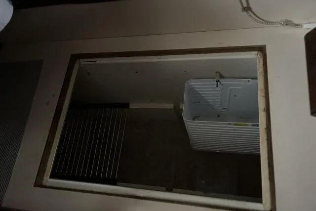 Slide: The Image of Interior compartment of a 1977 Uniflite Valiant 40 sailboat, featuring storage space. - 7