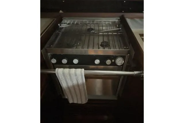 Slide: The Image of 1977 Uniflite Valiant 40 yacht kitchen stove with towel rack and control knobs. - 8