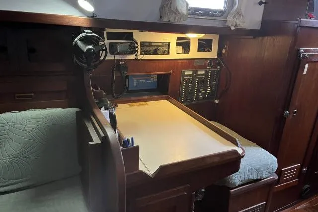 Slide: The Image of 1977 Uniflite Valiant 40 yacht interior with navigation station and communication equipment. - 9