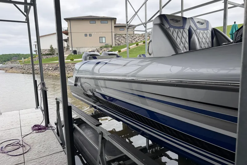 Slide: The Image of 2018 Sunsation 32 CCX boat docked, showcasing sleek design and luxurious seating. - 11