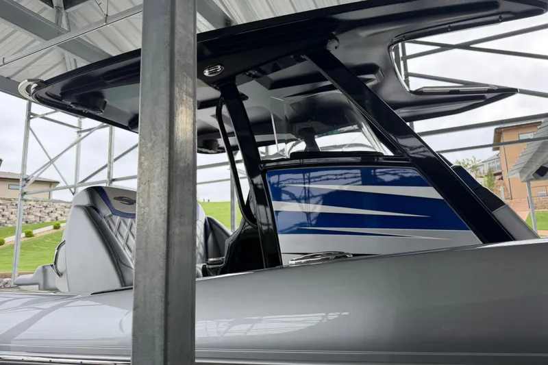 Slide: The Image of 2018 Sunsation 32 CCX boat with sleek design under a metal canopy. - 12