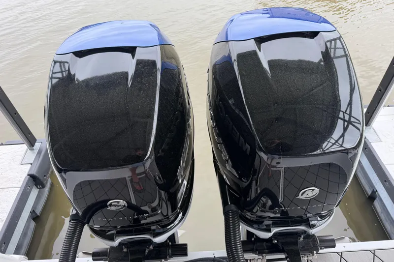 Slide: The Image of Twin Mercury outboard engines on a 2018 Sunsation 32 CCX boat at a dock. - 13