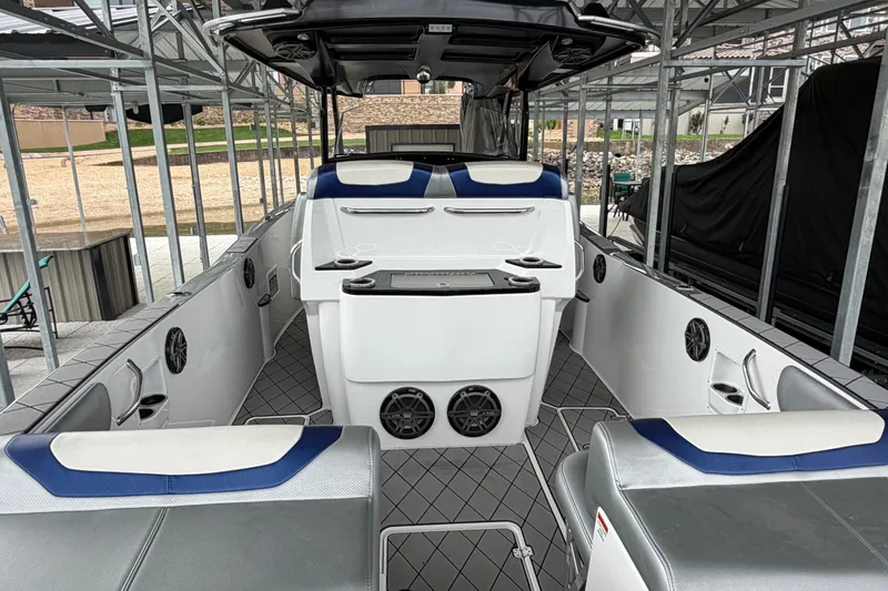 Slide: The Image of 2018 Sunsation 32 CCX boat interior with modern seating and sound system in a covered dock. - 14